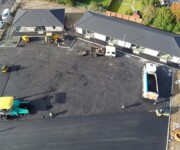 Drone shot of construction workers tarmacing carpark