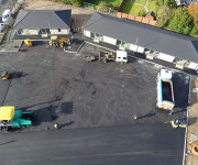 Drone shot of construction workers tarmacing carpark